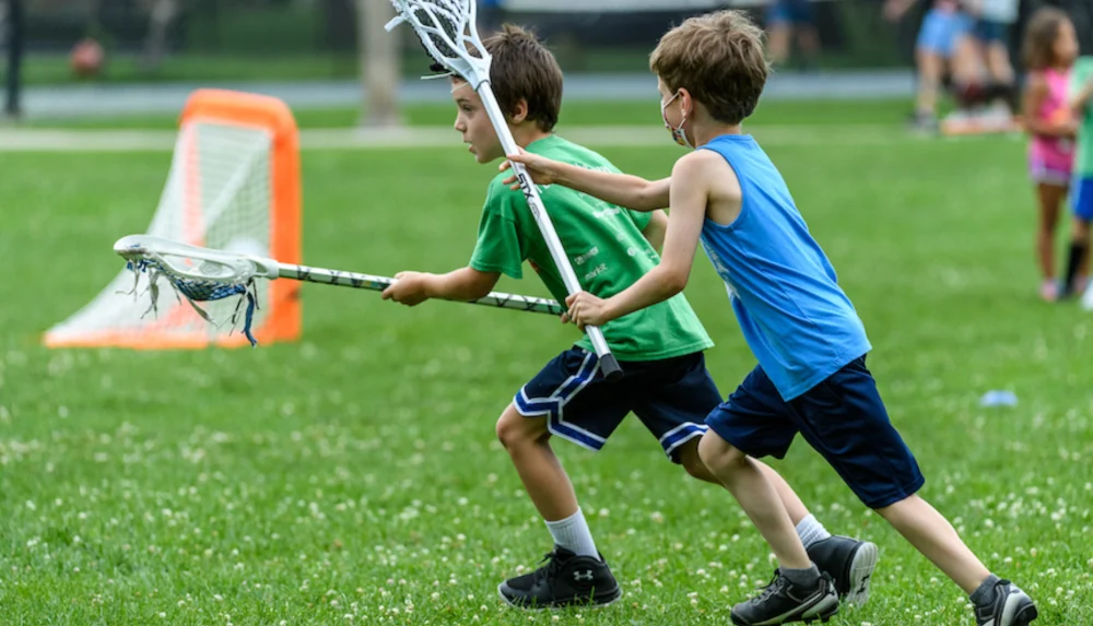 Kids playing lacrosse in Burlington highlighting youth sports readiness and injury prevention